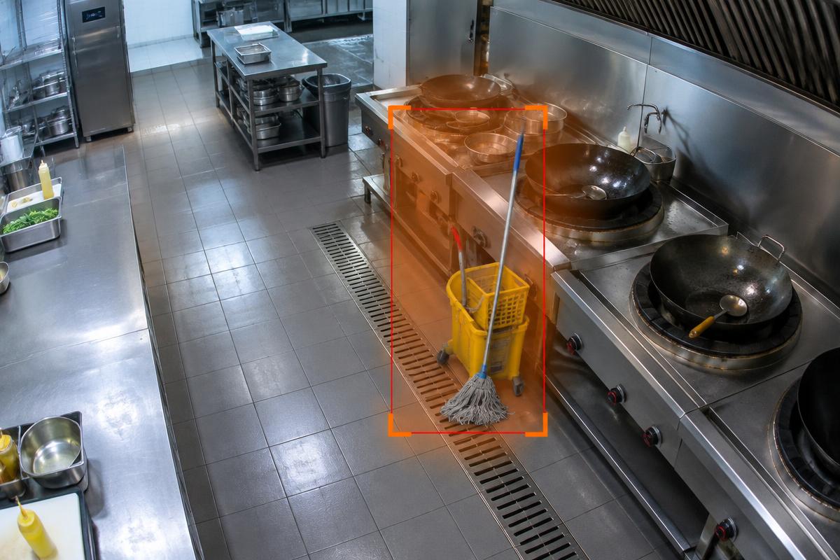 AI alert on a mop and bucket next to a wok station